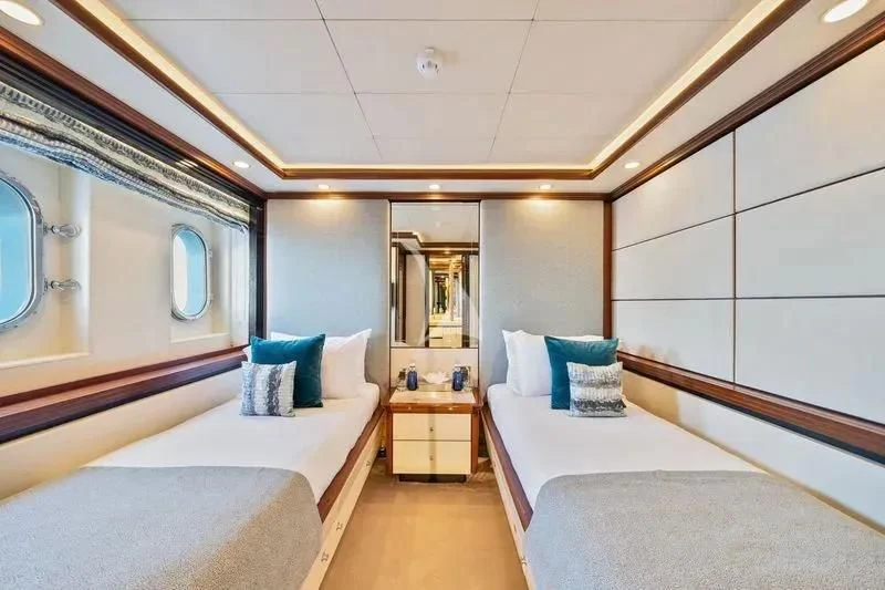 a room with a couple of beds aboard TITIAN PEARL Yacht for Sale