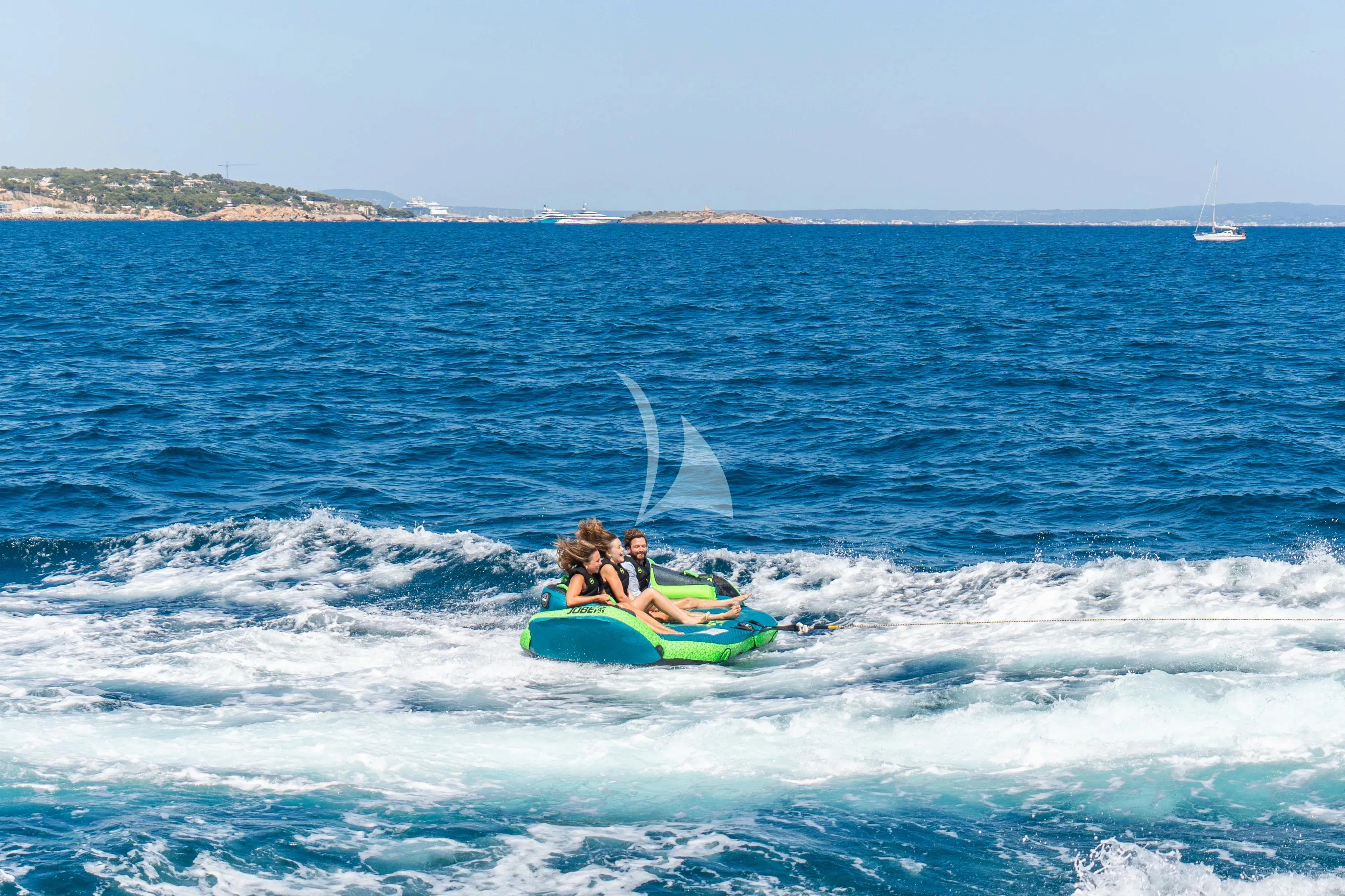 a man and a woman on a jet ski in the ocean aboard TITIAN PEARL Yacht for Sale