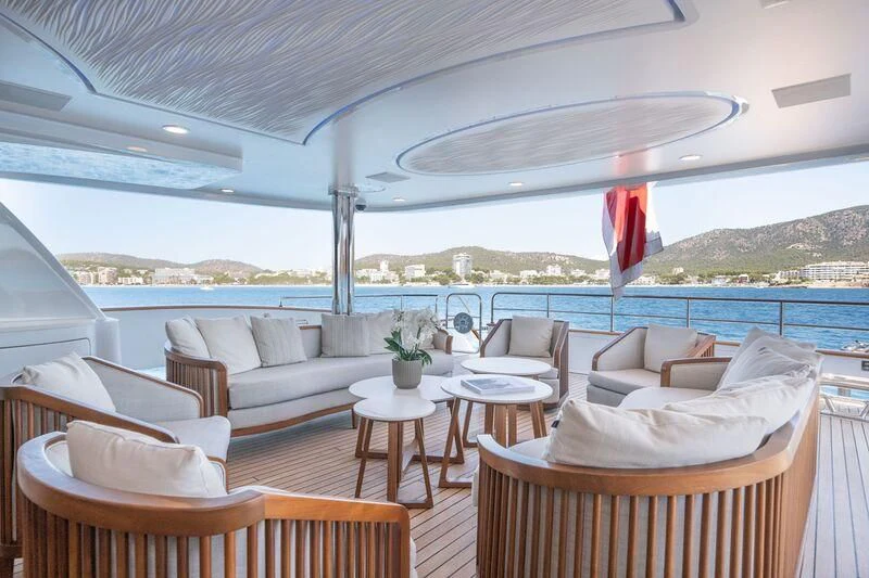 a patio with chairs and tables aboard TITIAN PEARL Yacht for Sale