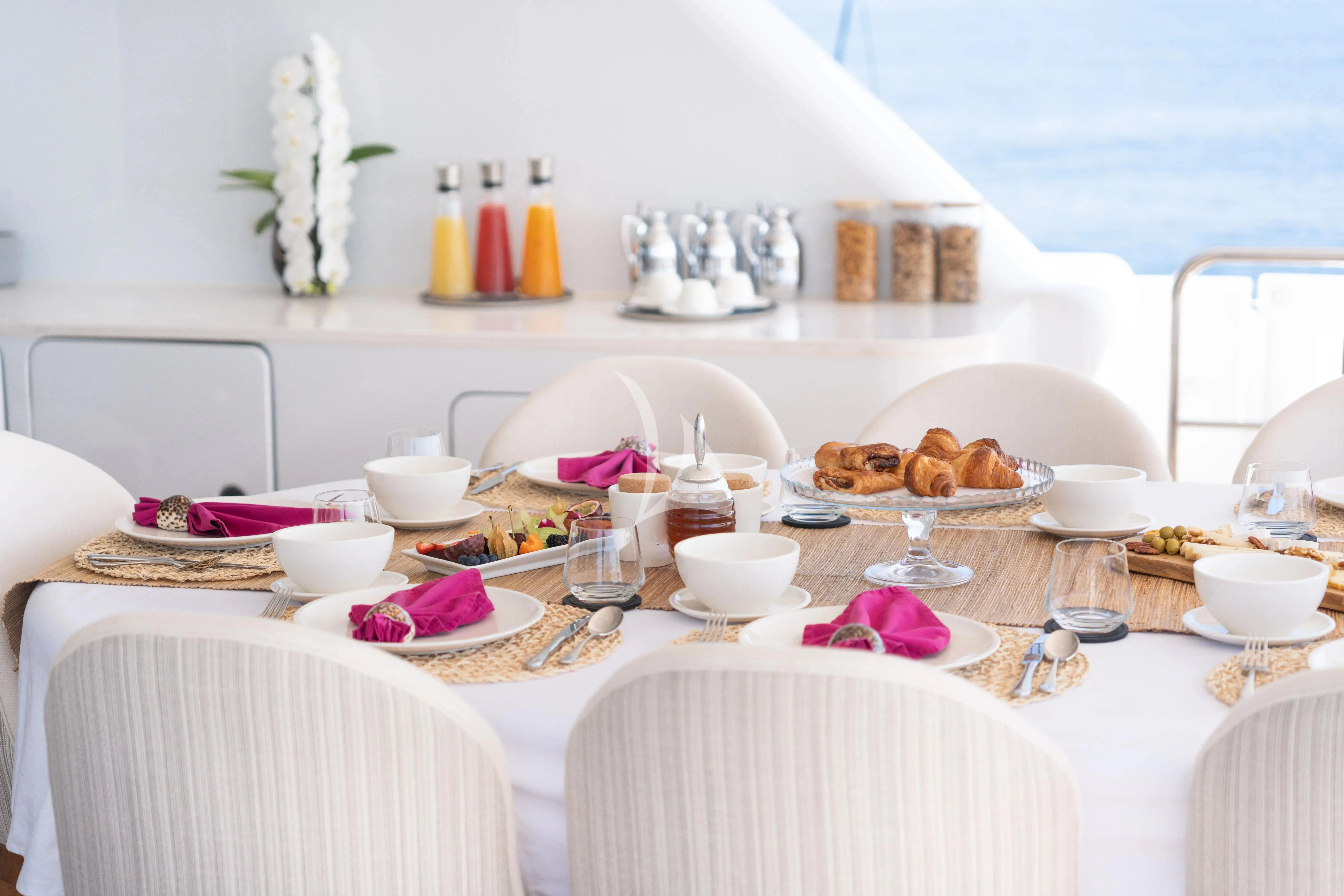 a table with food on it aboard TITIAN PEARL Yacht for Sale