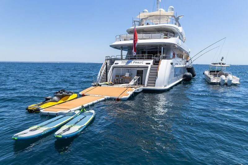 a boat and a boat in the water aboard TITIAN PEARL Yacht for Sale