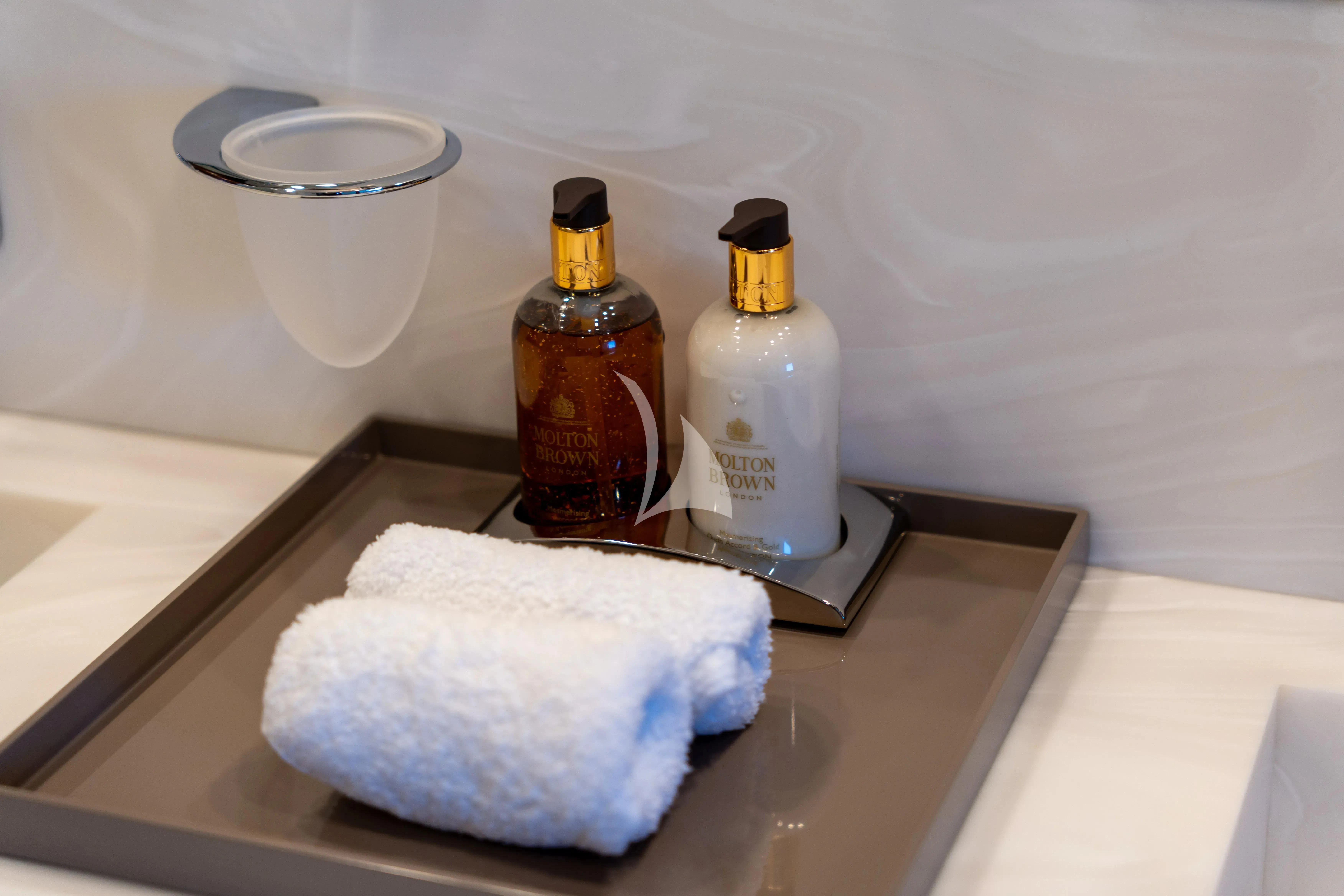 a bottle of liquor and a napkin on a counter aboard TITIAN PEARL Yacht for Sale