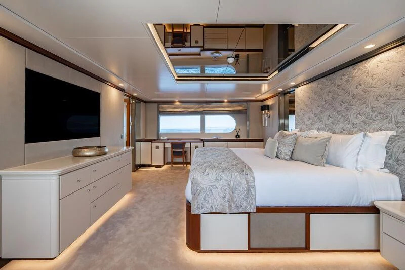 a room with a bed and a tv aboard TITIAN PEARL Yacht for Sale