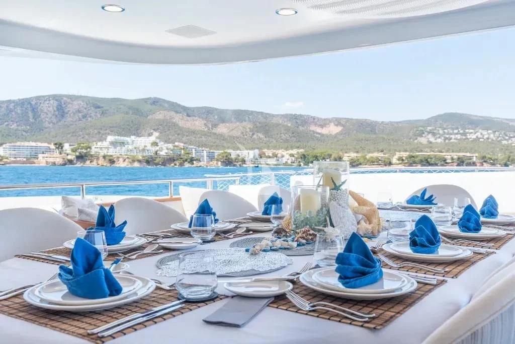 a table with plates and cups on it aboard TITIAN PEARL Yacht for Sale