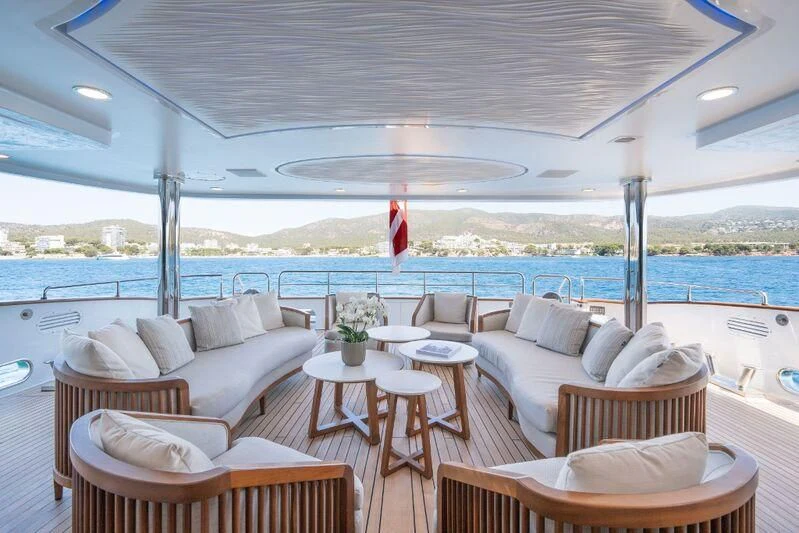a room with chairs and tables aboard TITIAN PEARL Yacht for Sale