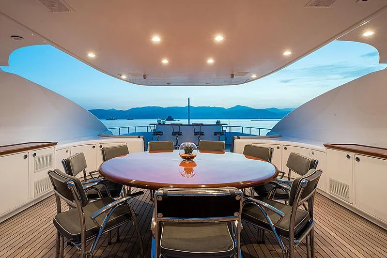 a table with chairs around it aboard TITIAN PEARL Yacht for Sale
