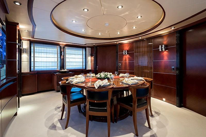 a dining table in a room aboard TITIAN PEARL Yacht for Sale