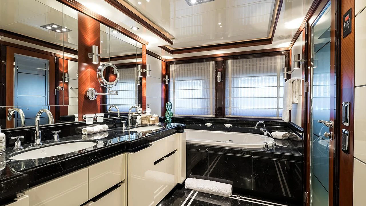 a bathroom with a sink and a mirror aboard TITIAN PEARL Yacht for Sale