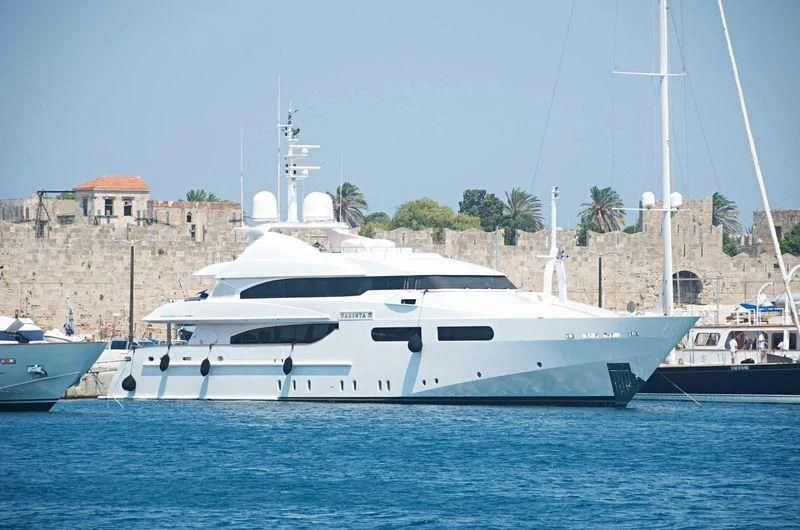 a white yacht in the water aboard TITIAN PEARL Yacht for Sale