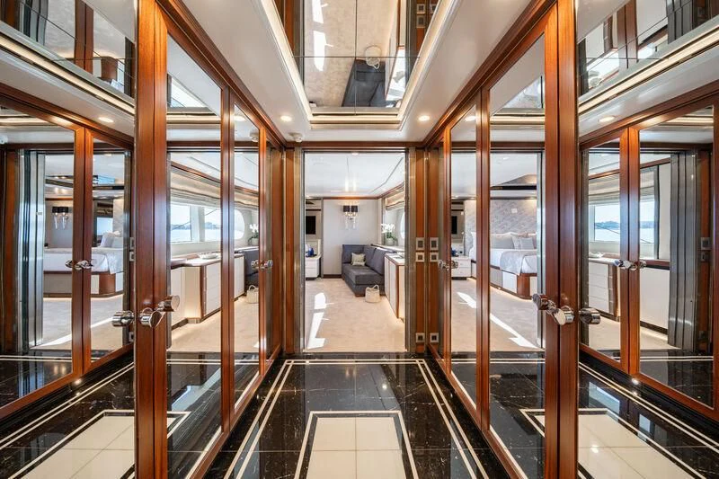 a hallway with glass doors aboard TITIAN PEARL Yacht for Sale