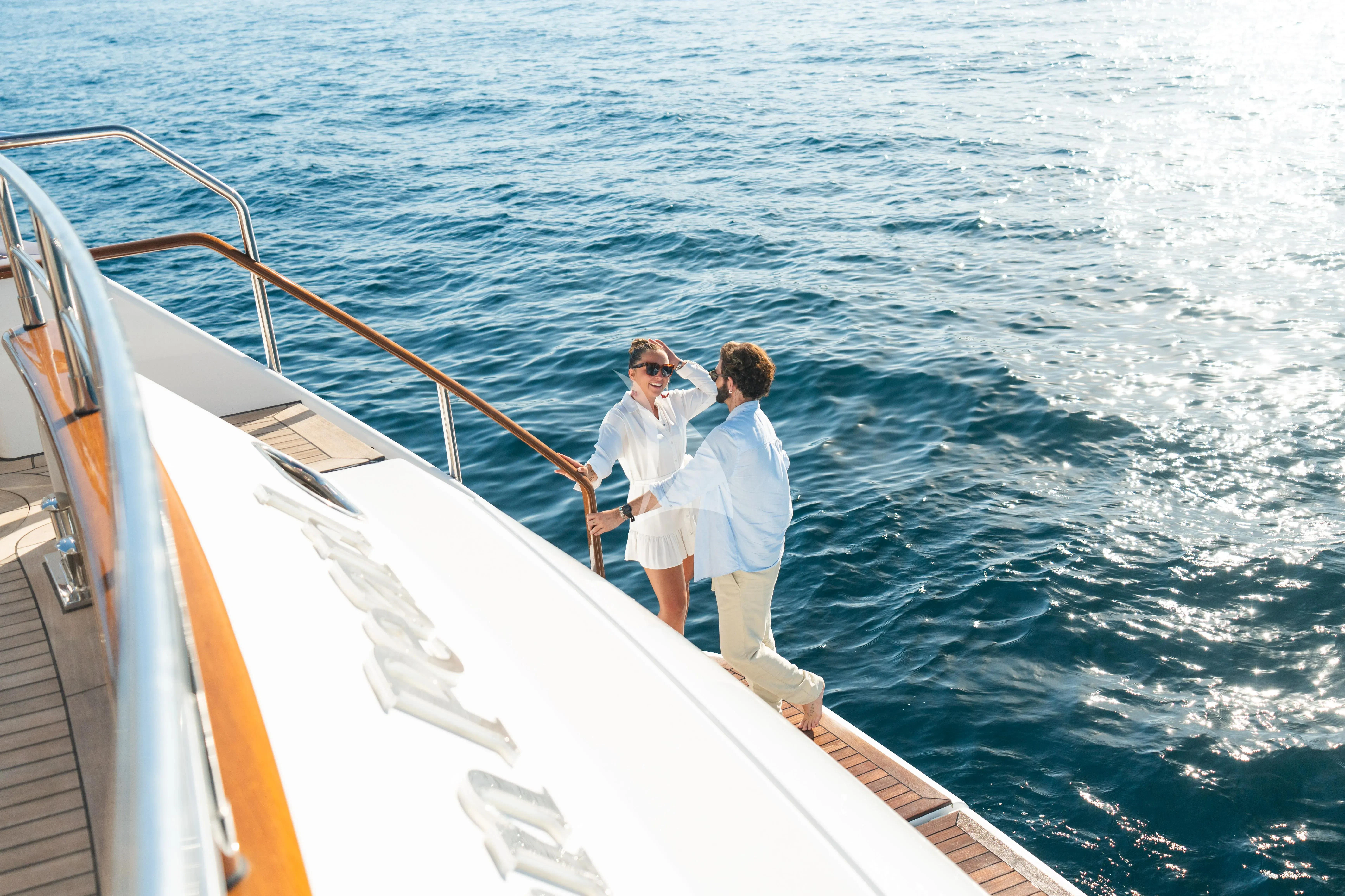a couple of people on a boat aboard TITIAN PEARL Yacht for Sale