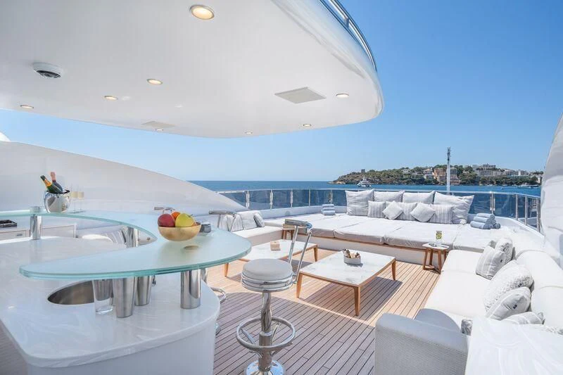 a pool with a table and chairs aboard TITIAN PEARL Yacht for Sale