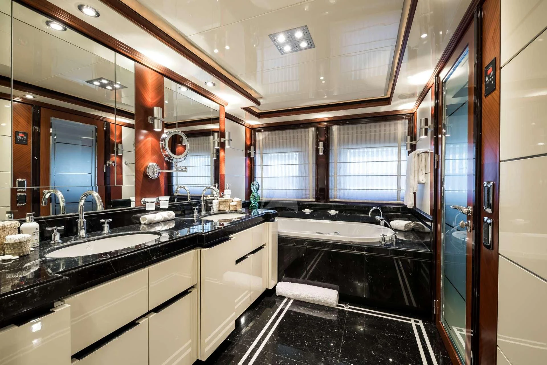 a kitchen with black counters aboard TITIAN PEARL Yacht for Sale