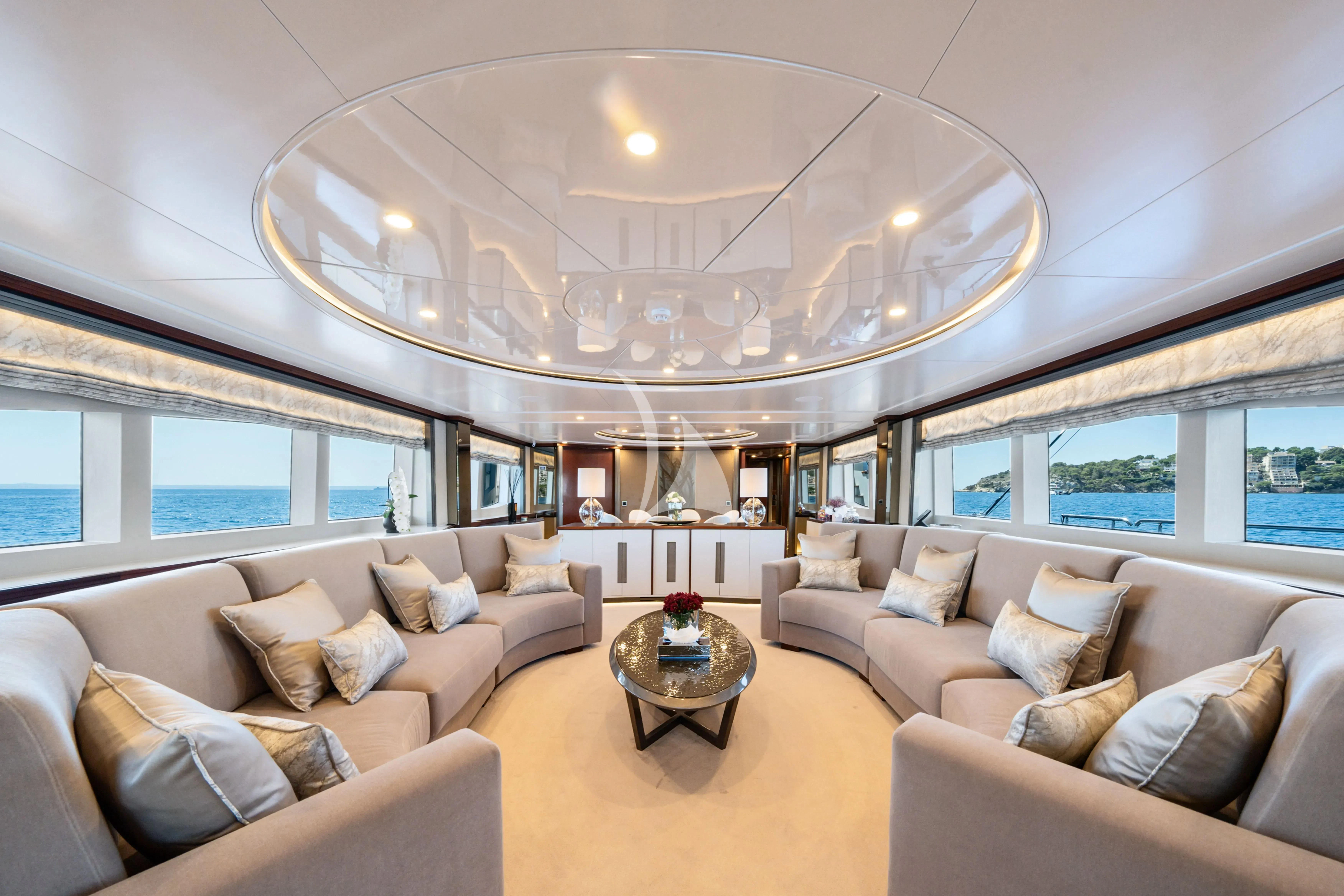 a living room with a large chandelier aboard TITIAN PEARL Yacht for Sale
