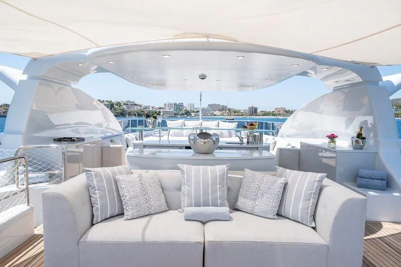 a large white lounge chair on a balcony overlooking a large body of water aboard TITIAN PEARL Yacht for Sale