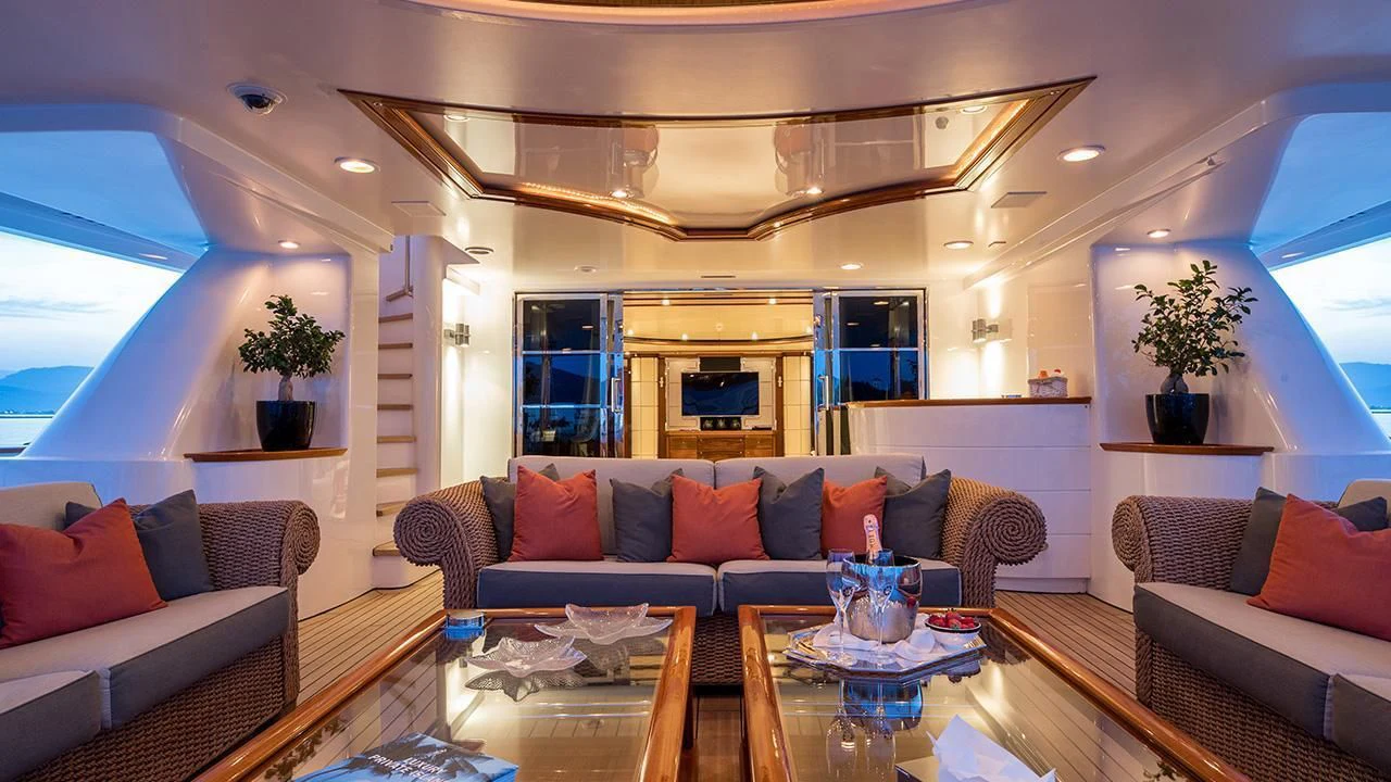 a living room with a couch and a table aboard TITIAN PEARL Yacht for Sale