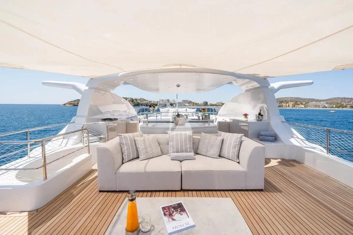 a large white lounge chair on a deck overlooking a large body of water aboard TITIAN PEARL Yacht for Sale