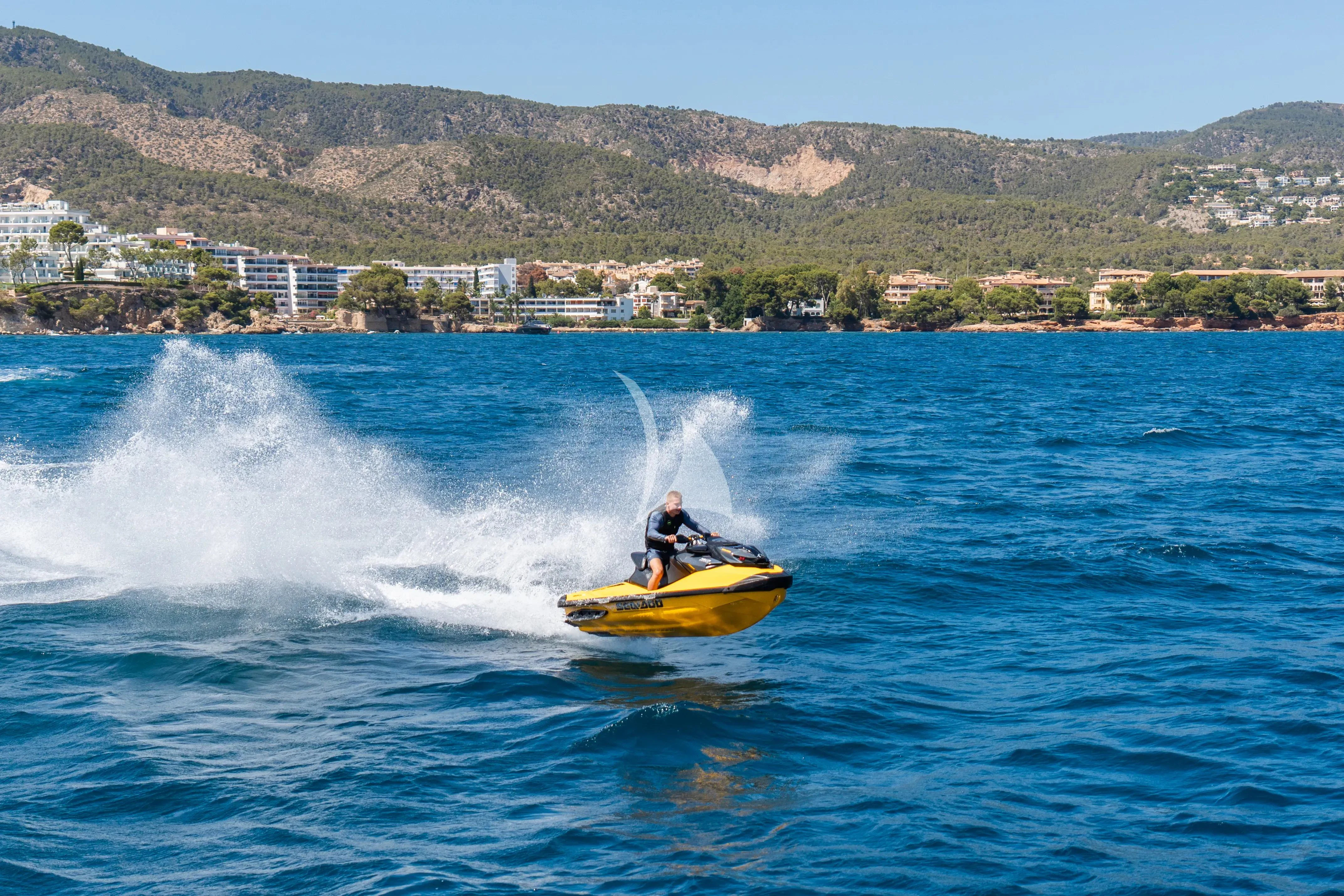 a person on a yellow kayak in the water aboard TITIAN PEARL Yacht for Sale