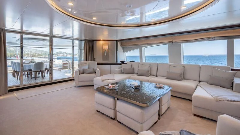 a living room with a large window aboard TITIAN PEARL Yacht for Sale
