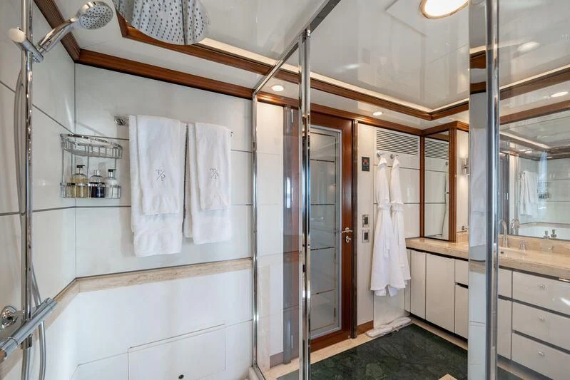 a bathroom with a shower unit and sink aboard TITIAN PEARL Yacht for Sale