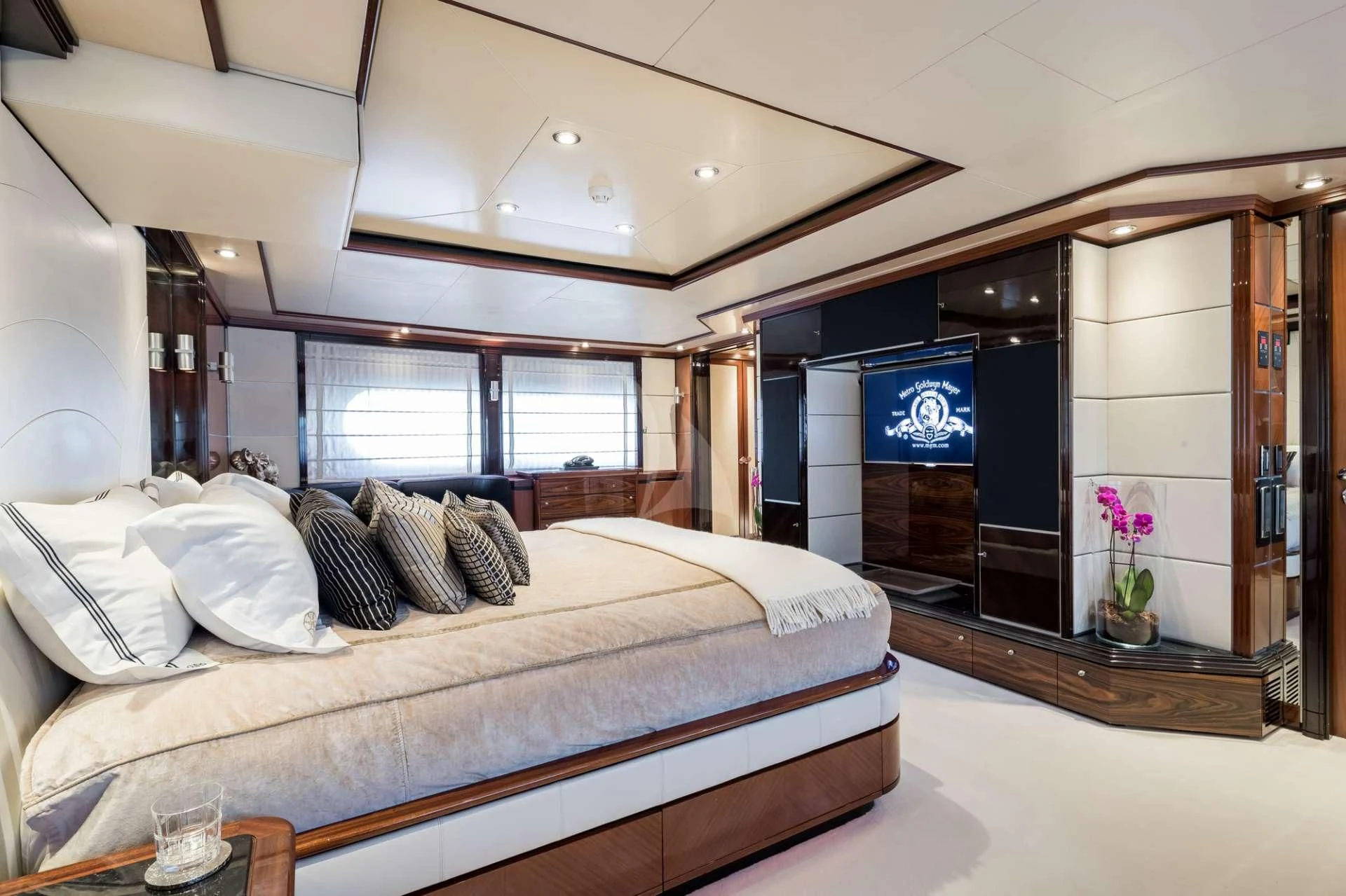 a bedroom with a bed and a fireplace aboard TITIAN PEARL Yacht for Sale