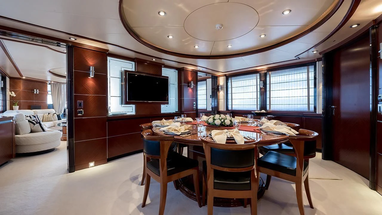a dining table in a room aboard TITIAN PEARL Yacht for Sale
