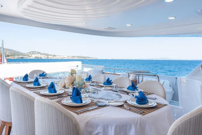 a table set for a dinner aboard TITIAN PEARL Yacht for Sale