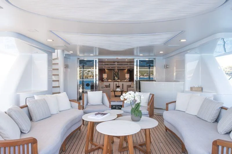 a living room with a couch and a table aboard TITIAN PEARL Yacht for Sale