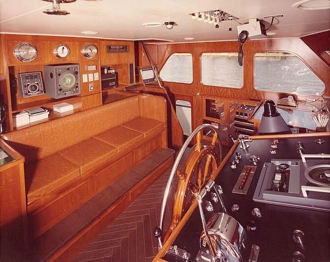 a kitchen with wooden cabinets aboard BLACKHAWK Yacht for Sale