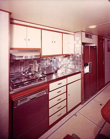 a kitchen with white cabinets aboard BLACKHAWK Yacht for Sale