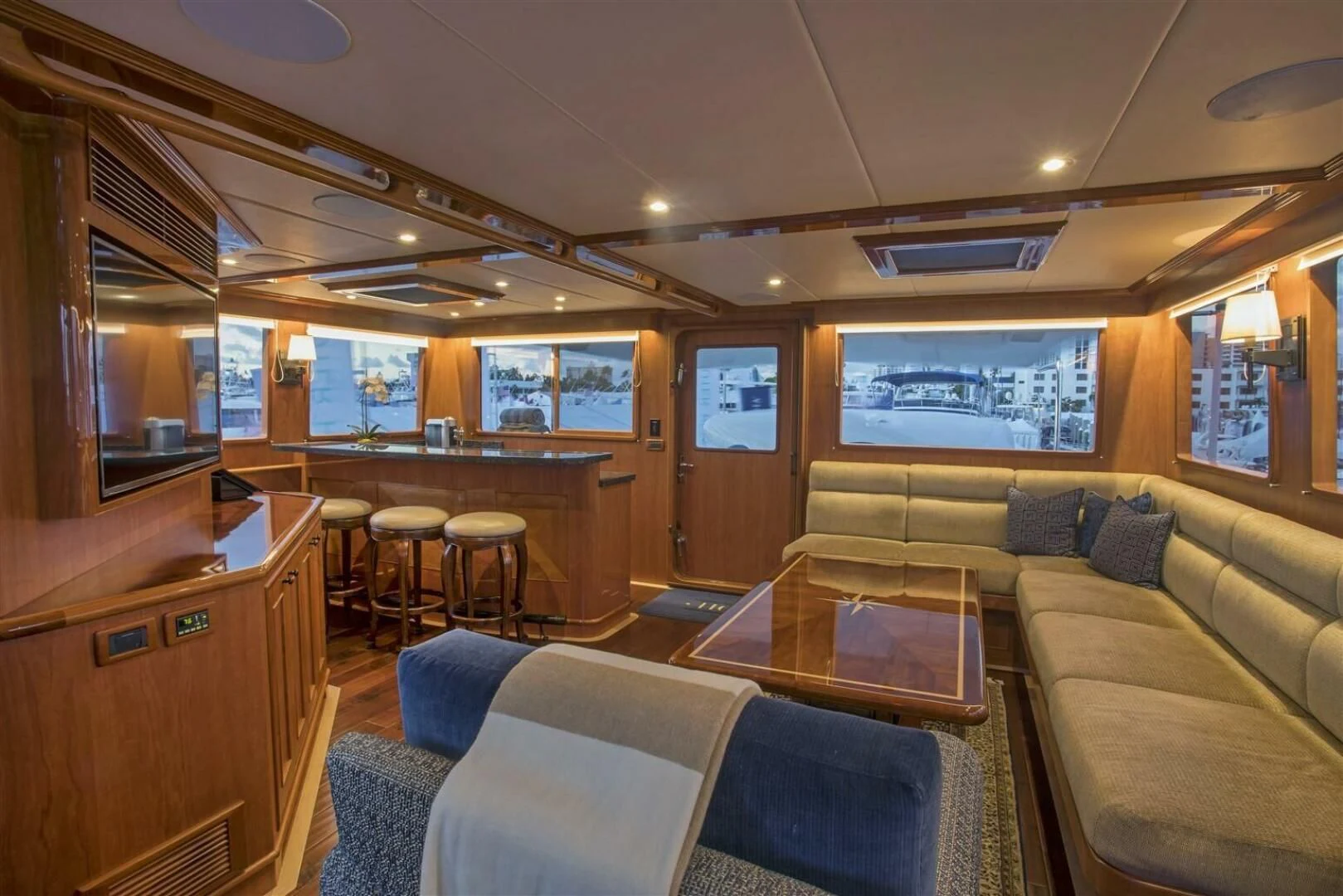 a room with a couch and a table and chairs aboard INSIGNIA Yacht for Sale