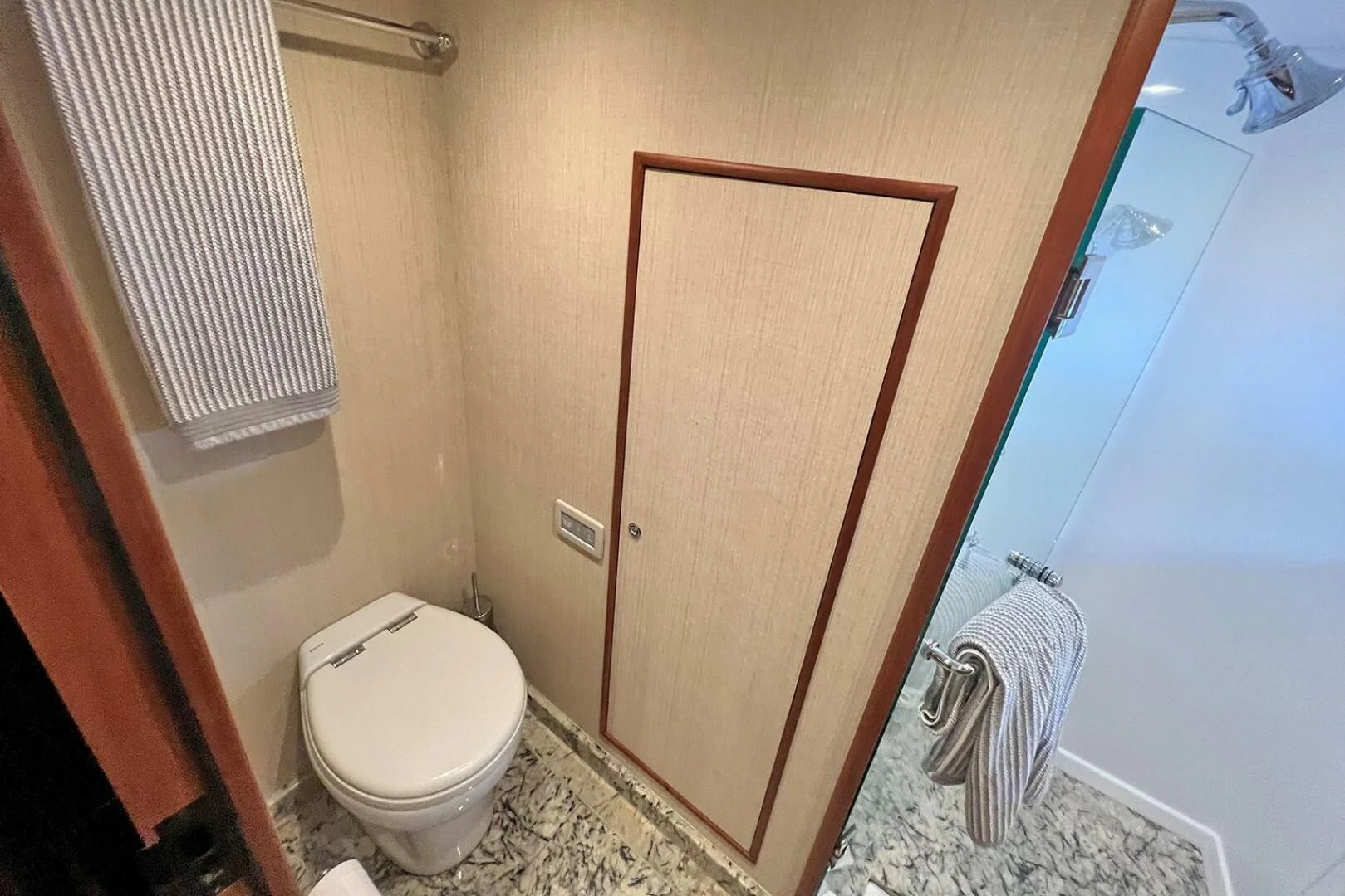 a bathroom with a toilet and a mirror aboard INSIGNIA Yacht for Sale
