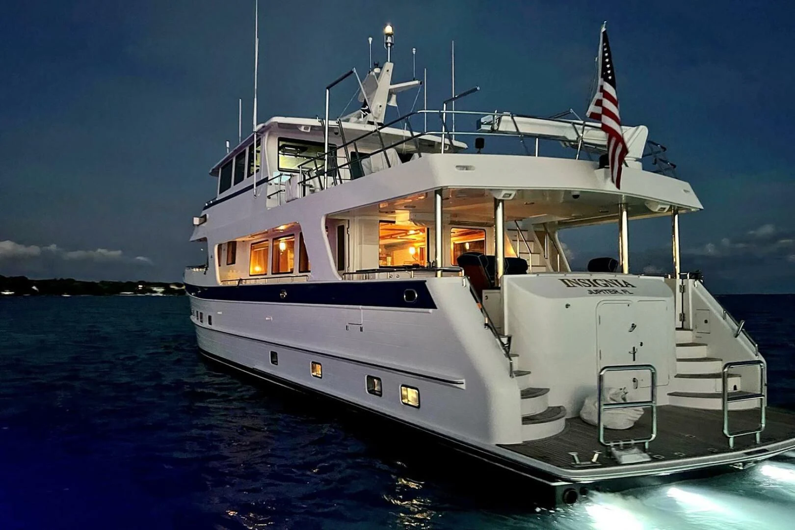 a large white boat in the water aboard INSIGNIA Yacht for Sale