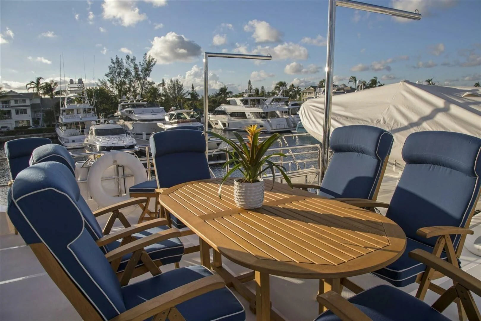a table and chairs on a deck overlooking a body of water aboard INSIGNIA Yacht for Sale
