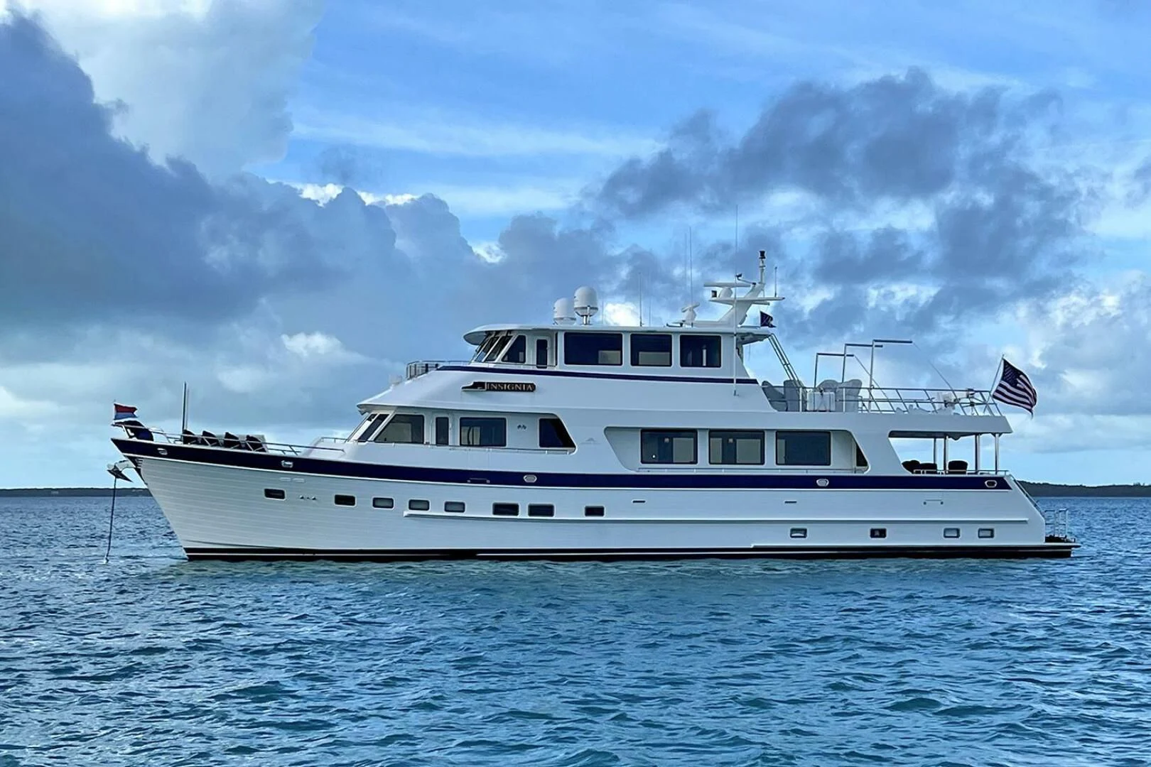 a large white boat in the water aboard INSIGNIA Yacht for Sale