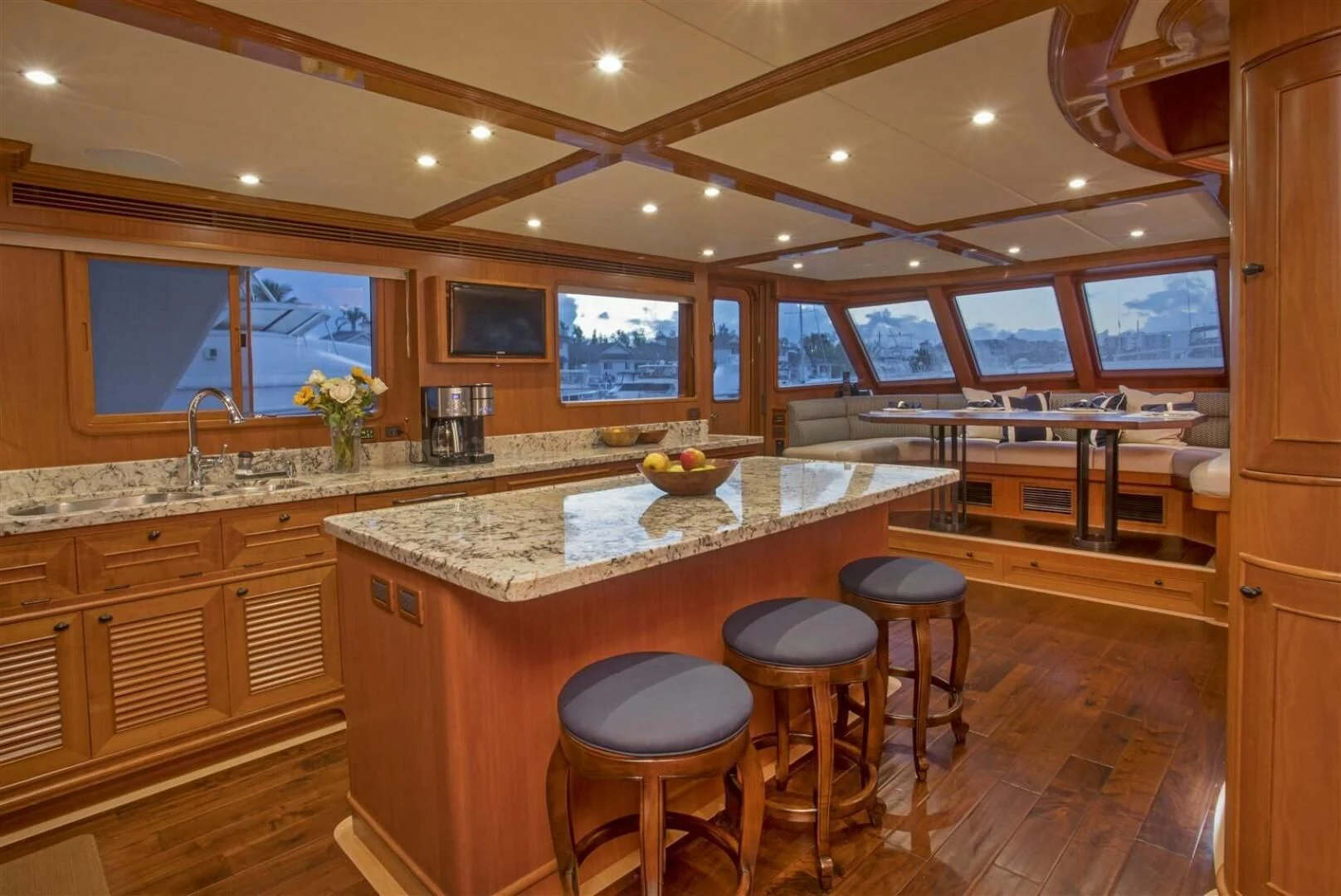 a kitchen with a bar and stools aboard INSIGNIA Yacht for Sale