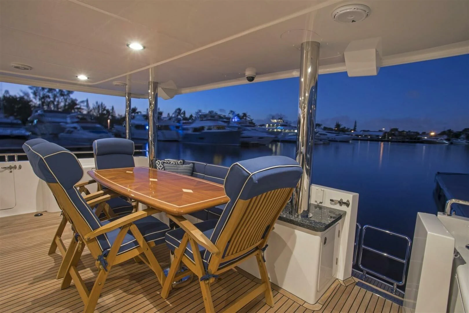 a table and chairs on a deck aboard INSIGNIA Yacht for Sale