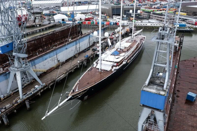 a large ship in a harbor aboard KORU Yacht for Sale
