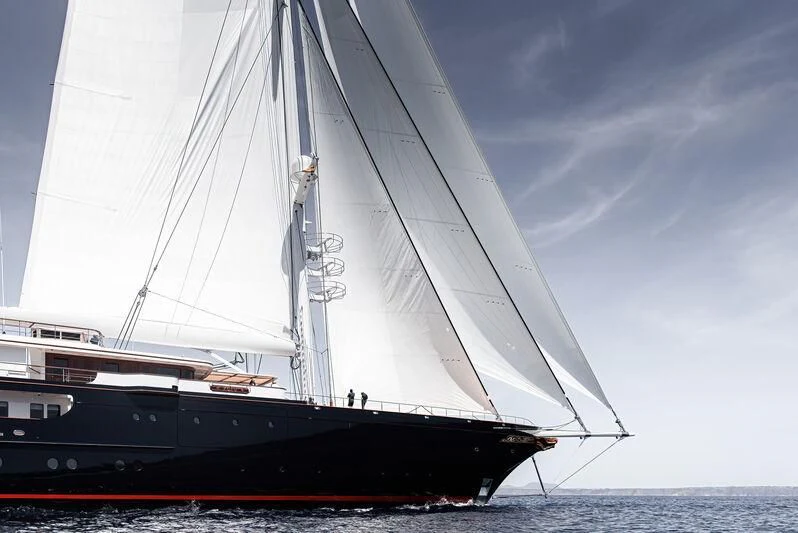 a large black boat on the water aboard KORU Yacht for Sale