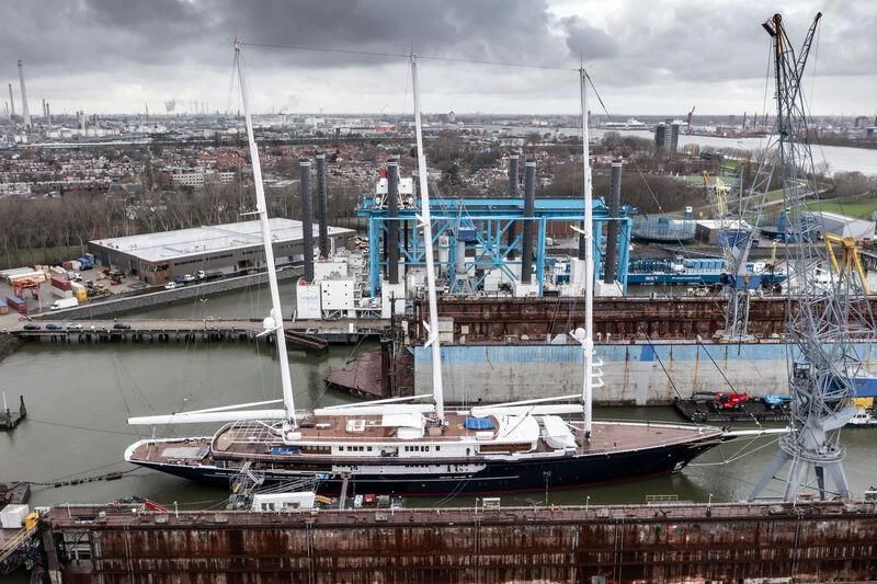 a large ship in a harbor aboard KORU Yacht for Sale