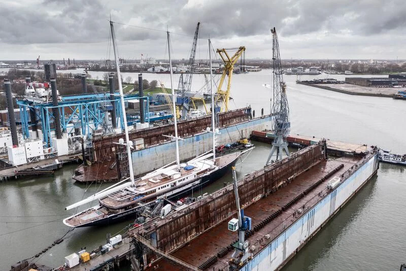 a large ship in a harbor aboard KORU Yacht for Sale