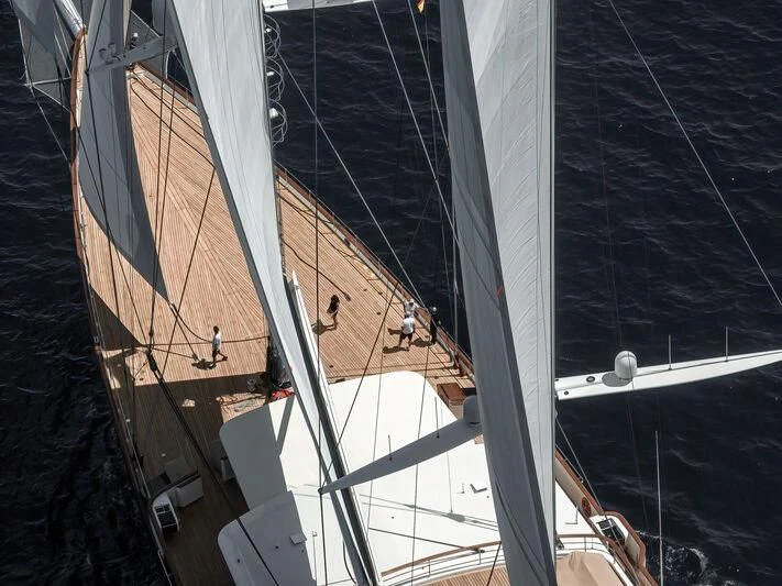 a large sailboat with many sails aboard KORU Yacht for Sale