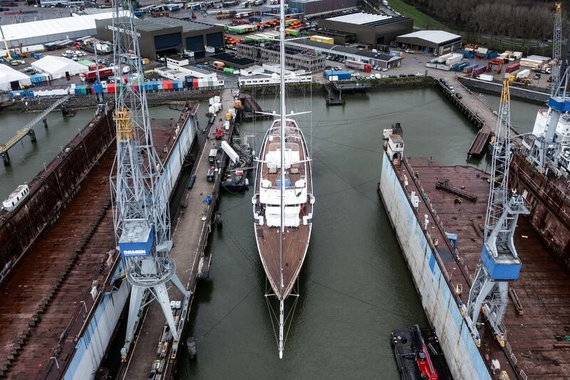 a large ship in a harbor aboard KORU Yacht for Sale