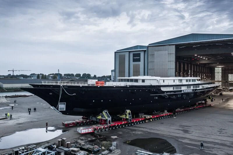 a large building with a train parked in front of it aboard KORU Yacht for Sale