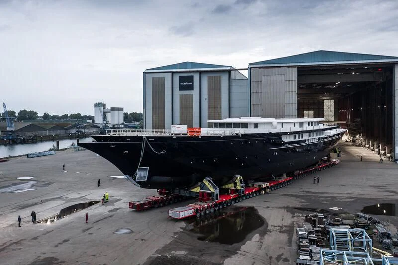 a large boat docked at a pier aboard KORU Yacht for Sale