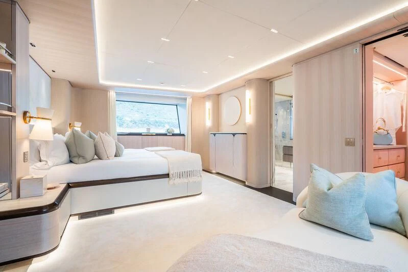 a bedroom with a bed and a window aboard PARA BELLVM Yacht for Charter