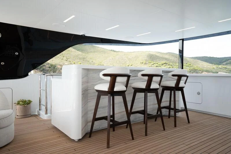 a room with tables and chairs aboard PARA BELLVM Yacht for Charter