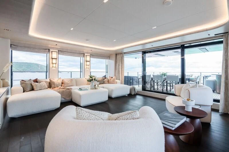 a living room with a large window aboard PARA BELLVM Yacht for Charter