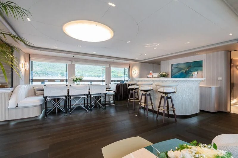 a large living room with a large table and chairs aboard PARA BELLVM Yacht for Charter
