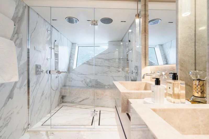a bathroom with a glass shower aboard PARA BELLVM Yacht for Charter